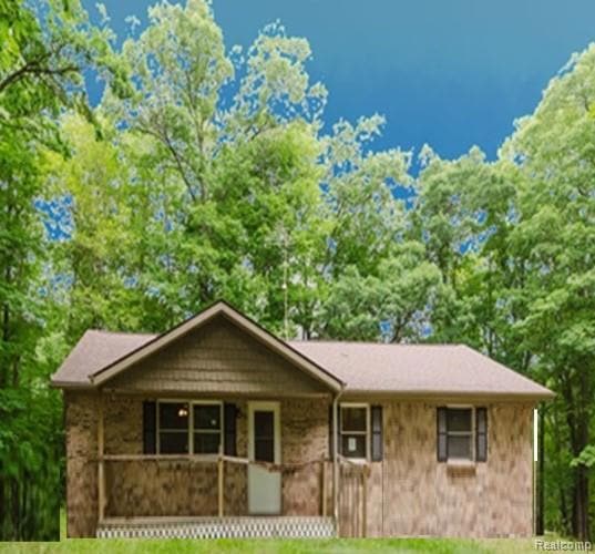 View of front of home featuring a porch and a front lawn