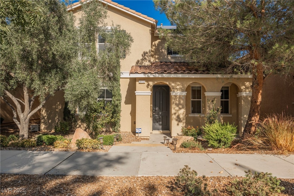 Mediterranean / spanish-style house featuring stucco siding, a tiled roof, and covered porch