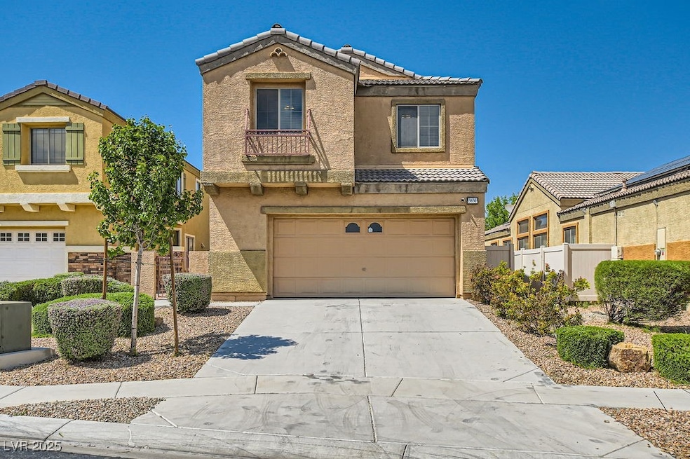 View of property with stucco siding, a garage, con