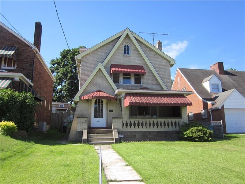 Stylish Tudor with large front porch, curb appeal!