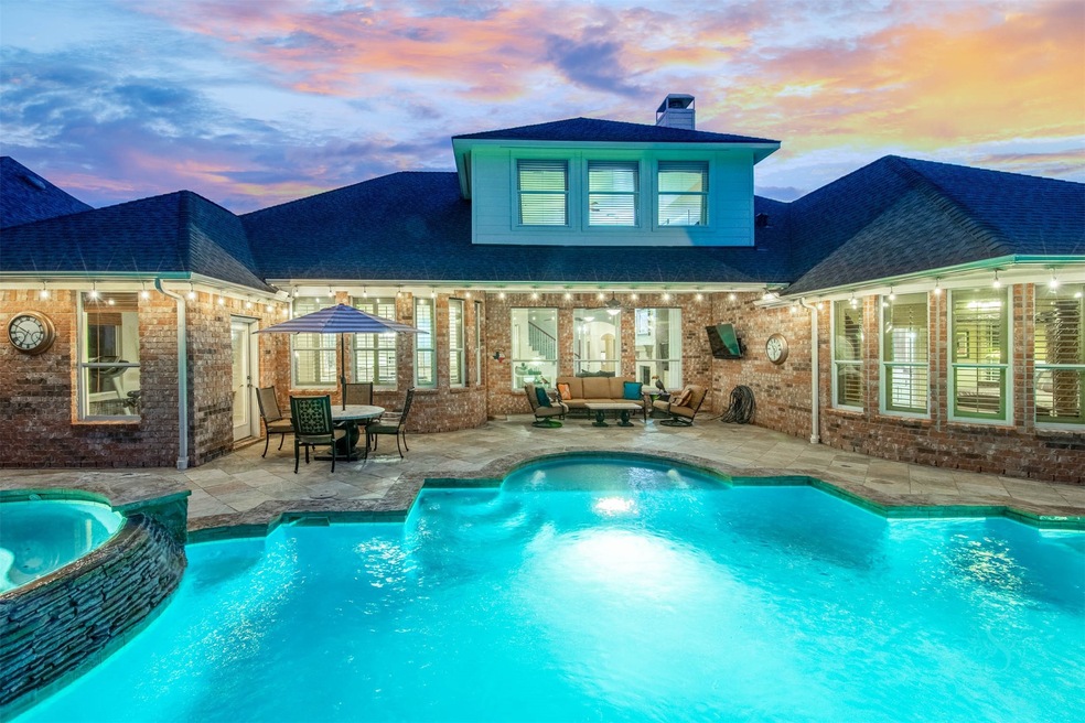 Welcome to this backyard tropical paradise! From the slate decking, outdoor lighting, covered patio and gorgeous landscaping. You will fall in love with this backyard.