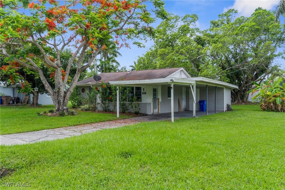 View of front of house with a front yard and an at