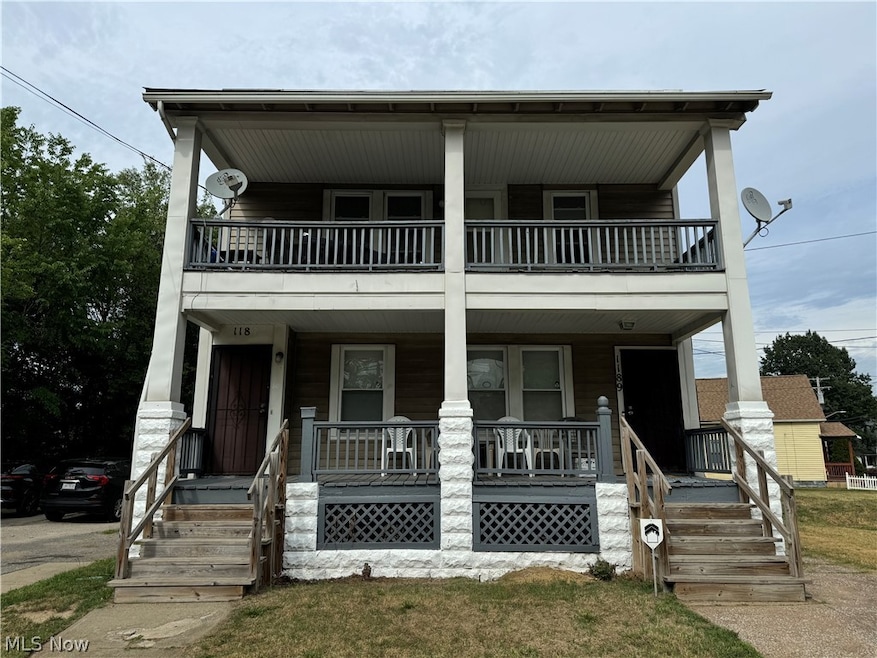 View of front facade with covered porch and a balcony
