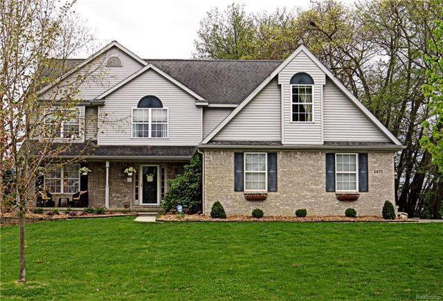 A cement walkway leads from garage to home's front