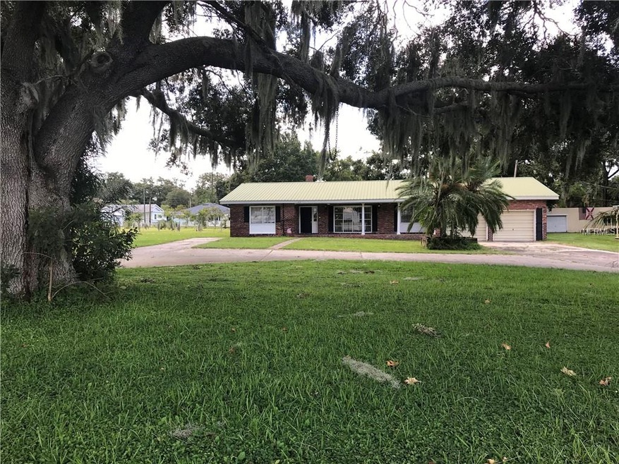 VIEW FROM FRONT YARD UNDER BEAUTIFUL OAKS
