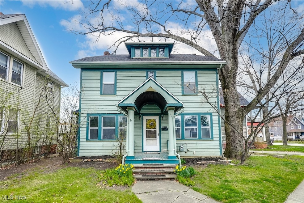 American foursquare style home with a front lawn