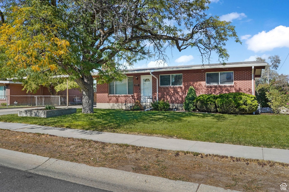 Ranch-style house featuring brick siding and a front yard
