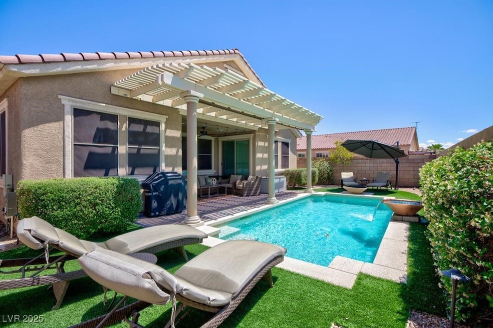 View of swimming pool with a pergola, outdoor loun
