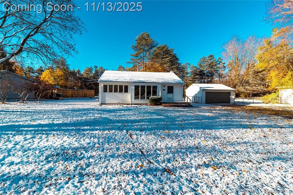View of front facade featuring an outdoor structure and a garage