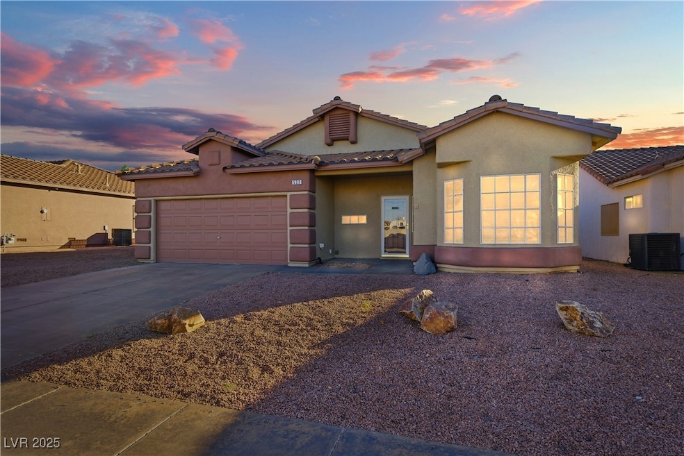 Mediterranean / spanish-style home featuring driveway, stucco siding, an attached garage, and a tiled roof