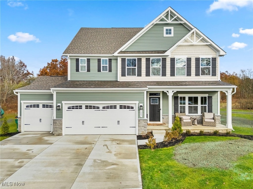 Craftsman-style house with a porch, stone siding, concrete driveway, a shingled roof, and a front yard