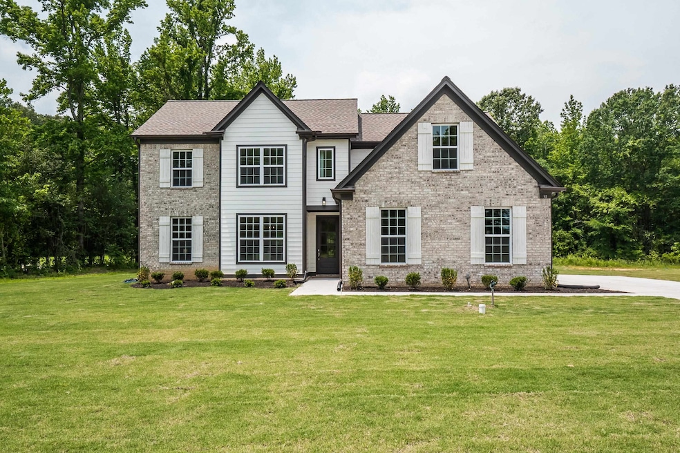 View of front of house featuring brick siding and a front lawn