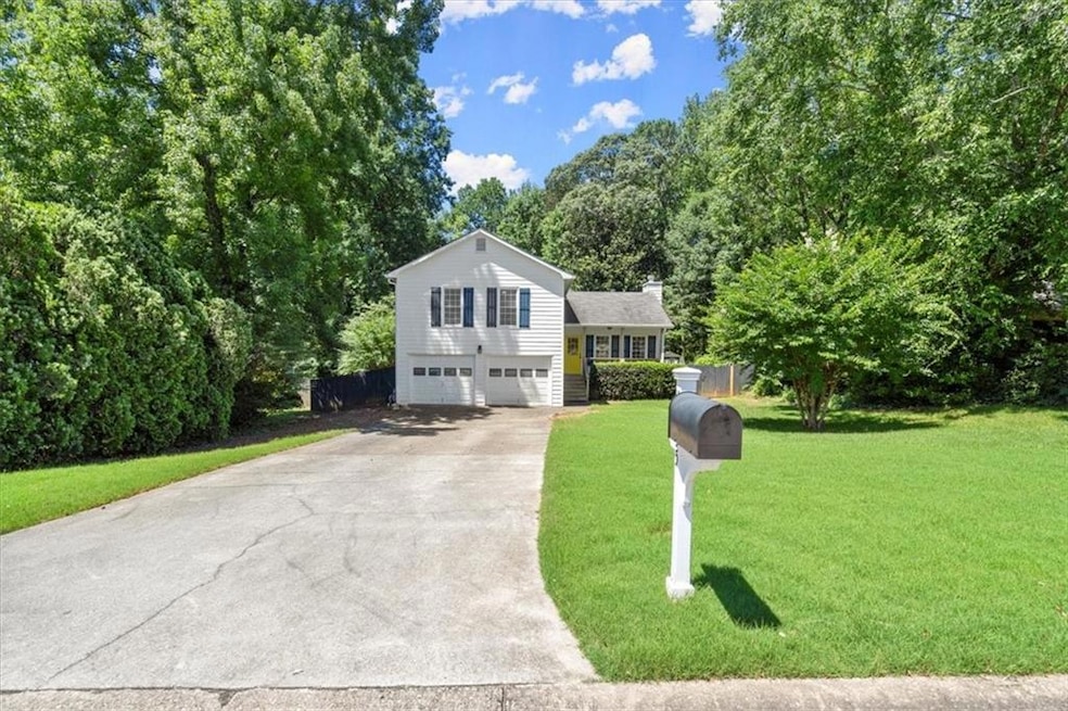 Tri-level home with a garage and a front yard