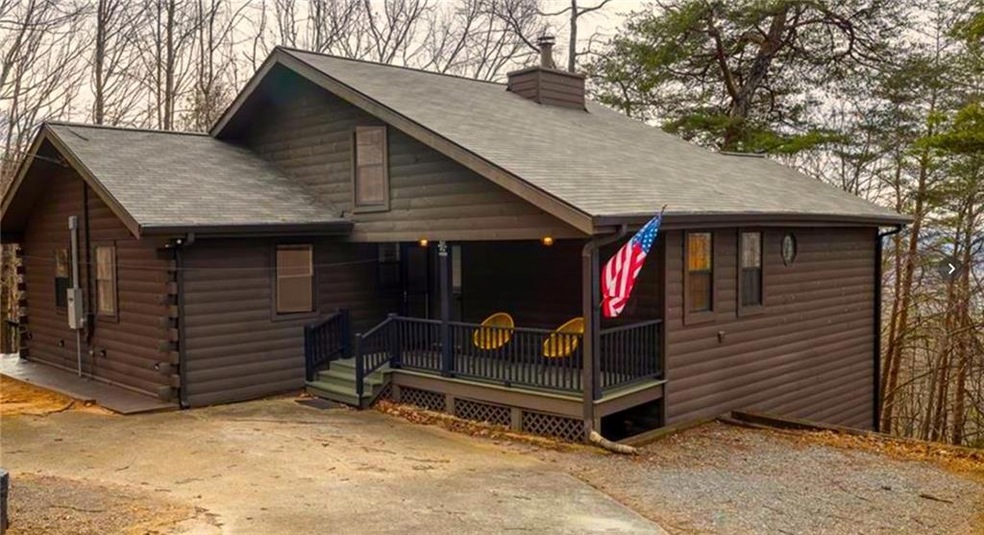 Beautiful log home with welcoming sitting front po