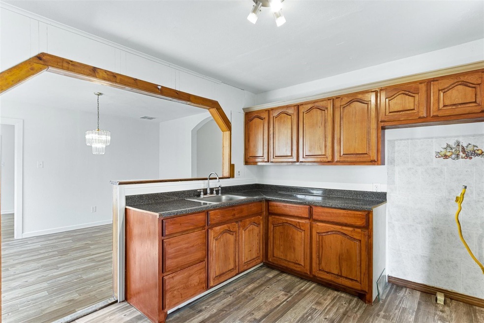 Kitchen with sink, dark hardwood / wood-style floo