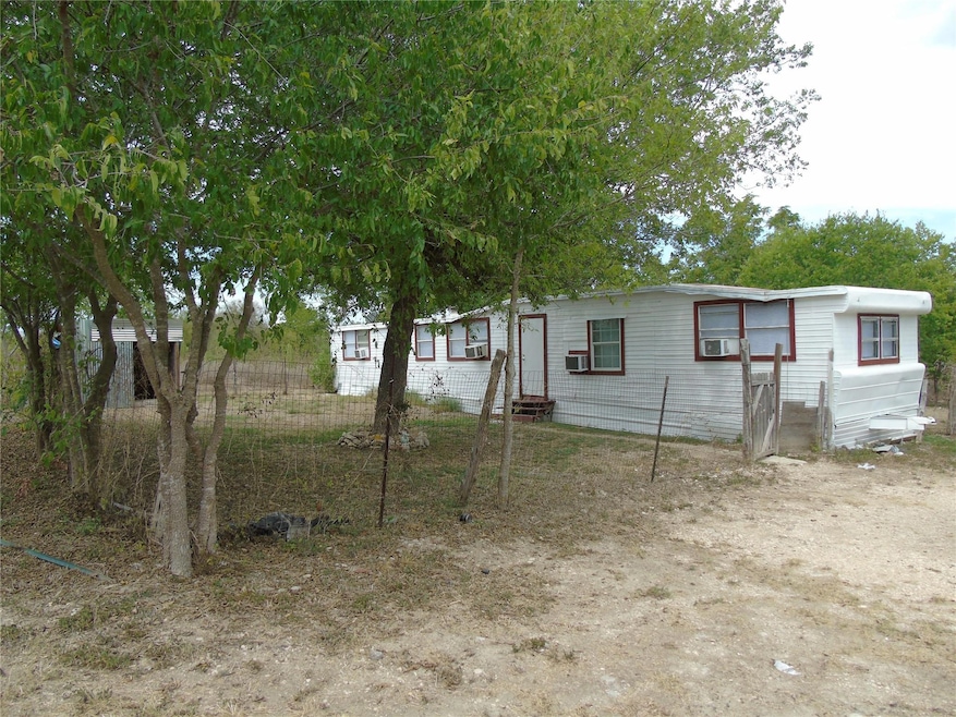View of front facade with entry steps and cooling unit