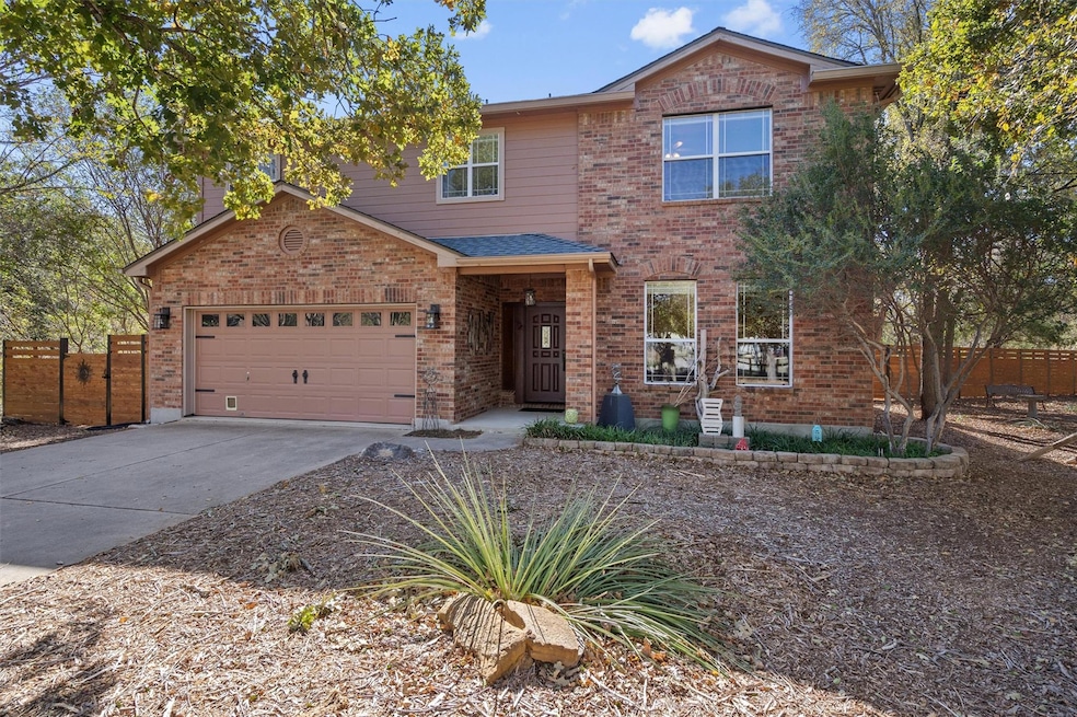 Traditional-style house with driveway, a garage, and brick siding