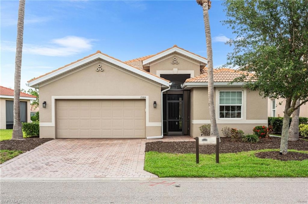 View of front of property with decorative driveway, stucco siding, a garage, and a tile roof