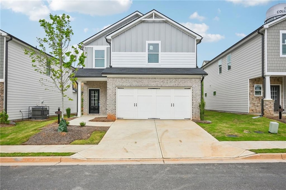 View of front of property featuring a garage, cool