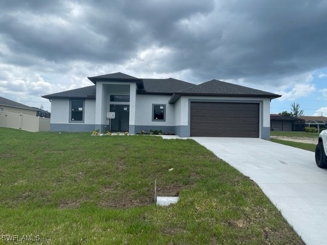 Prairie-style home featuring stucco siding, drivew