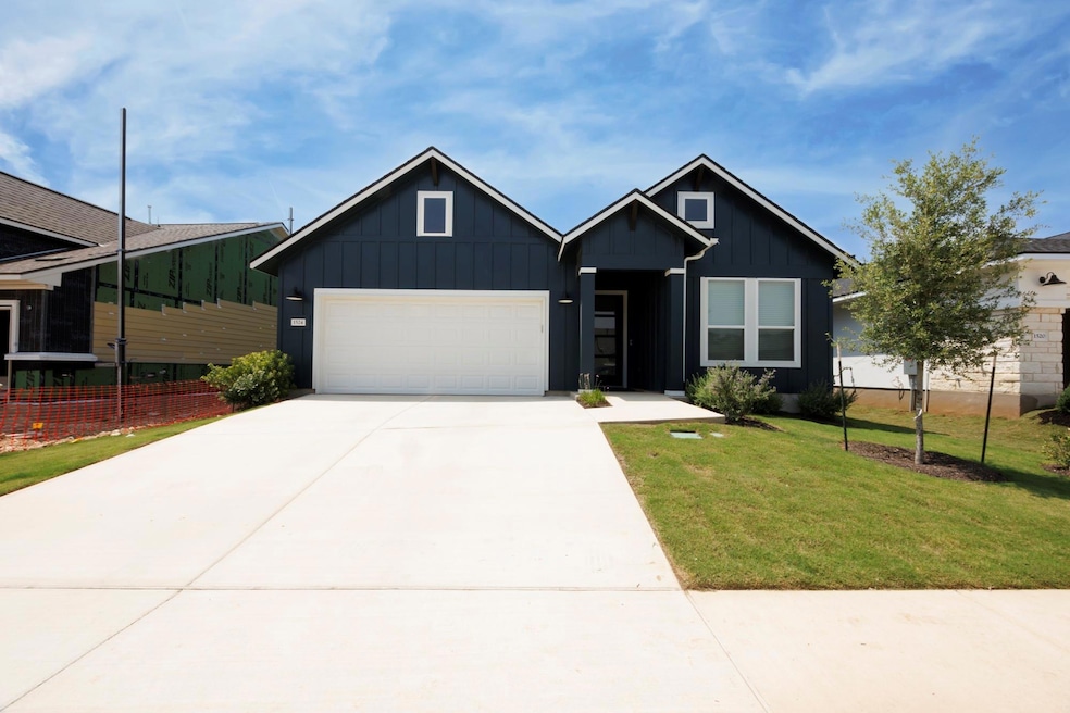 View of front of house featuring a garage, concre