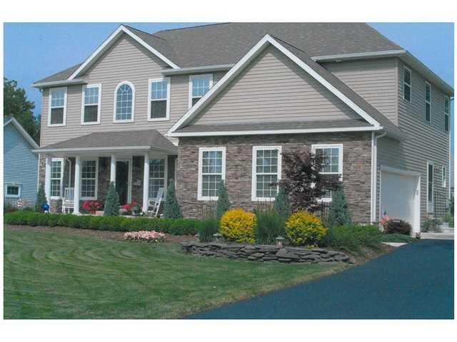 Exterior Front. Architectural stone on facade and 