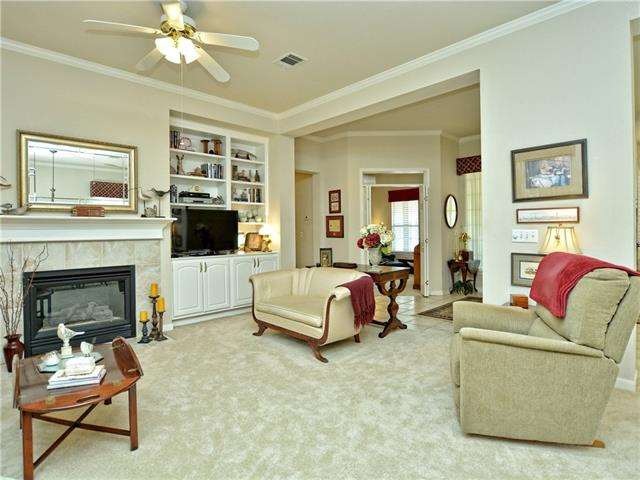 Built-in wooden shelving and hearth accent the gas