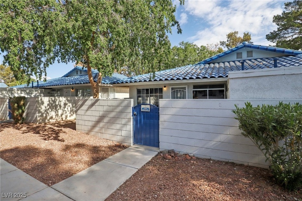 Ranch-style house featuring a gate, stucco siding,