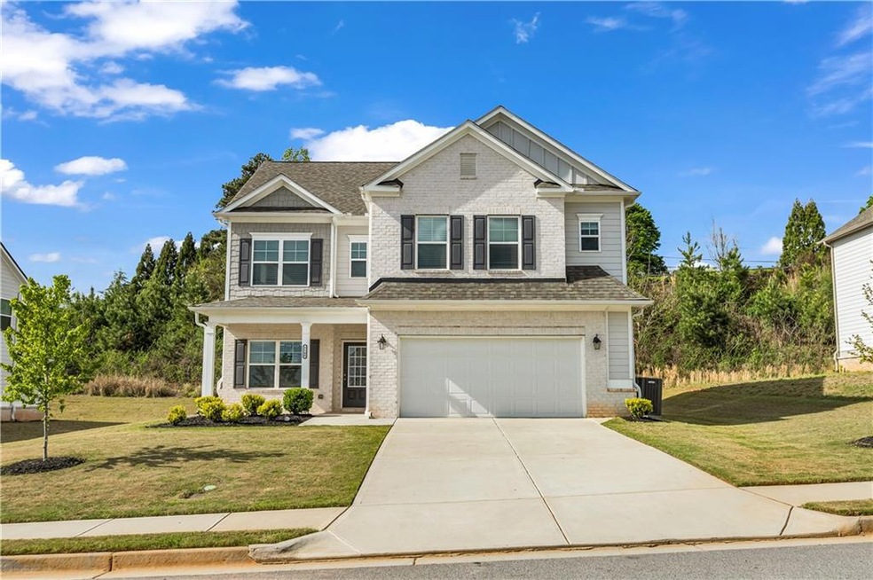 Craftsman house featuring brick siding, a front lawn, concrete driveway, and an attached garage