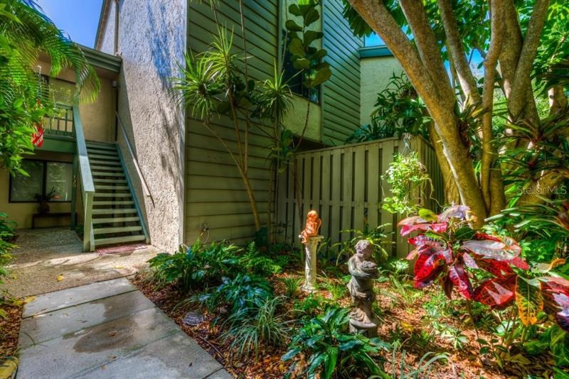 The lovely garden welcomes you home. The carport a