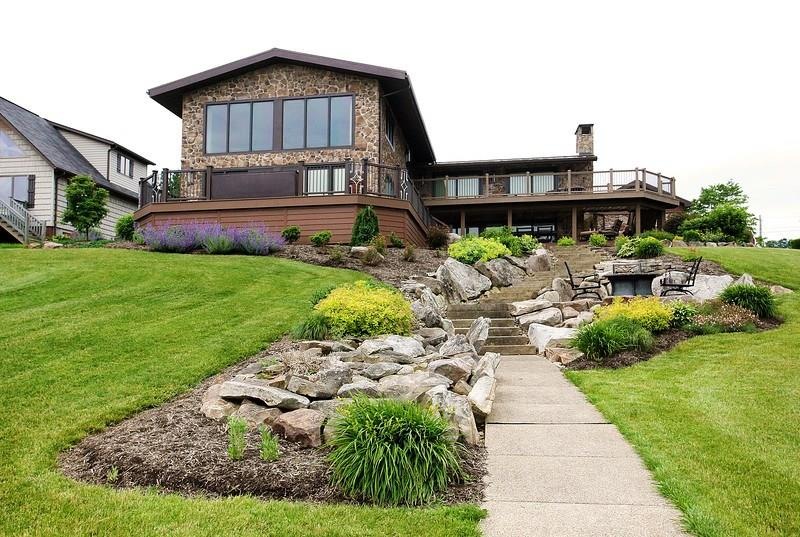 View from Lake.  Stone house with beautiful landsc