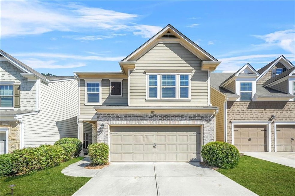 Townhome / multi-family property featuring driveway and an attached garage