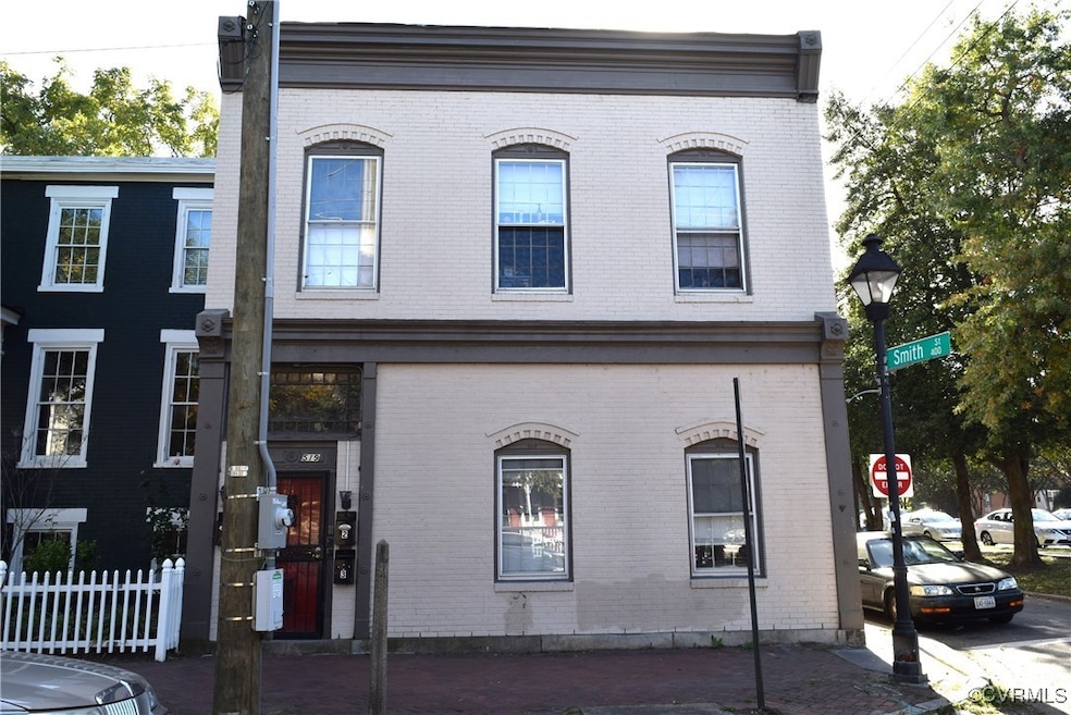 Townhome / multi-family property featuring brick s