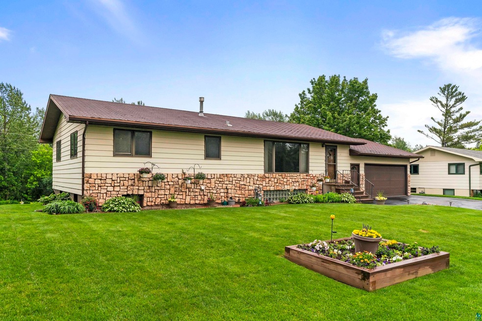 View of front of home featuring a garage and a front yard
