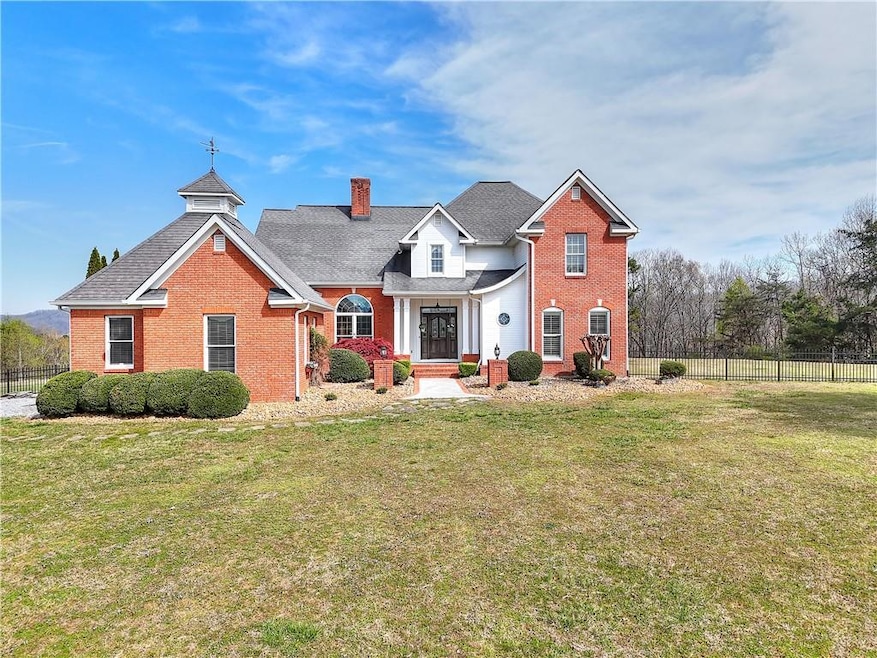 Traditional home with a chimney, brick siding, fen