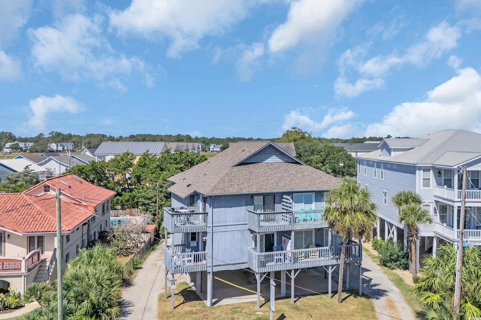 Rear view of property with a balcony, a residential view, and a shingled roof