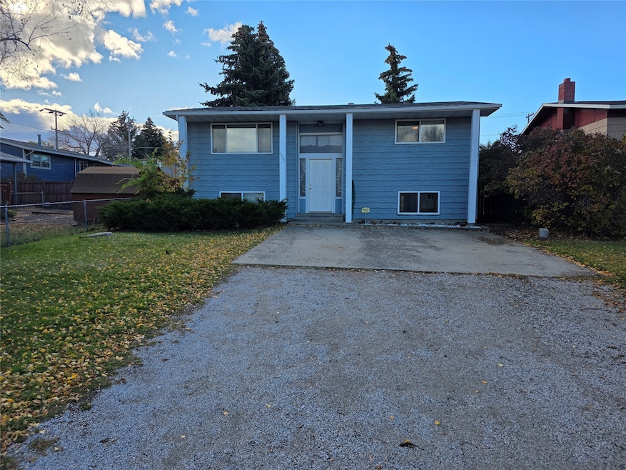 Split foyer home with gravel driveway