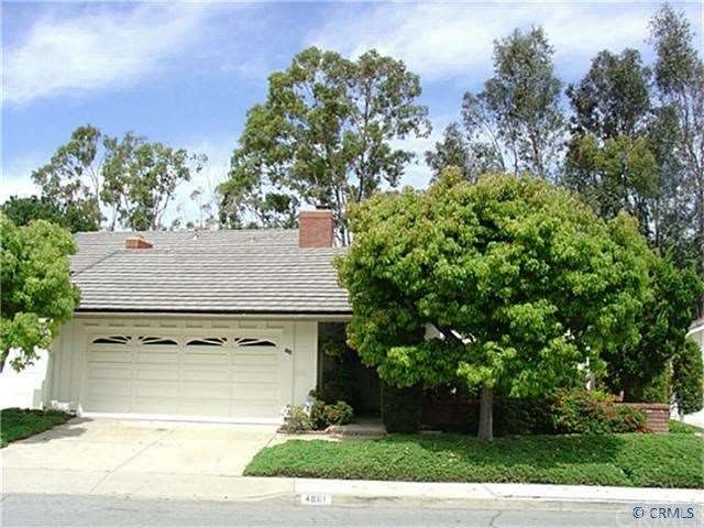 Birght home wrapped in Mature Trees & Landscaping
