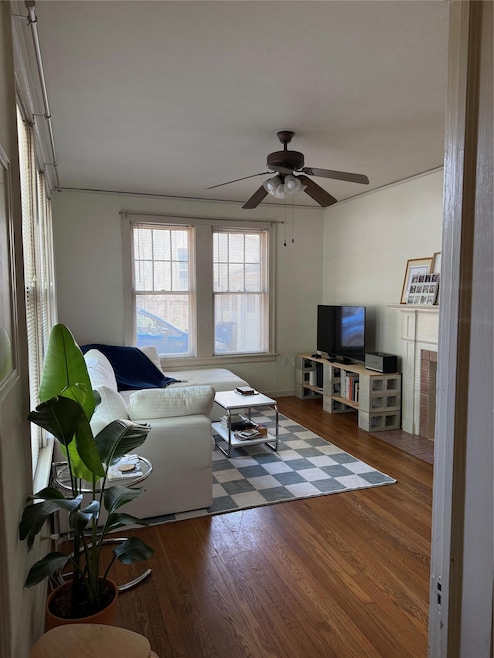 Living room with wood finished floors and a ceili
