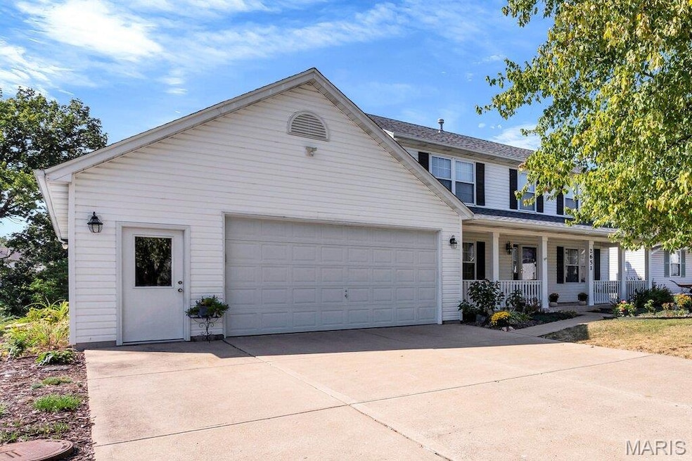 View of front of house featuring a porch, concrete driveway, an attached garage, and roof with shingles