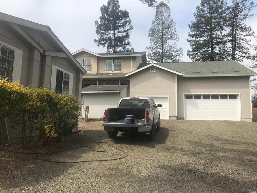 Manufactured home is front left, unfinished home i