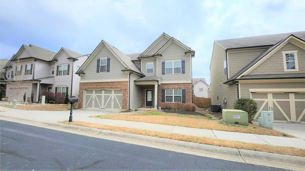 Craftsman-style home featuring brick siding, concrete driveway, an attached garage, and central air condition unit