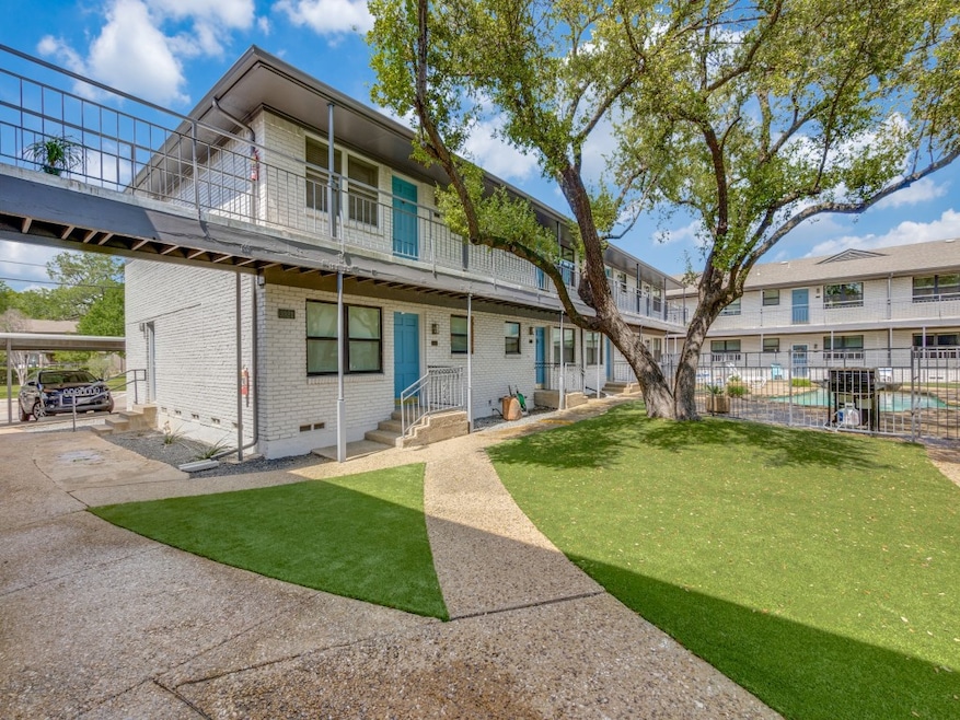 View of front facade featuring brick siding, a balcony, and crawl space