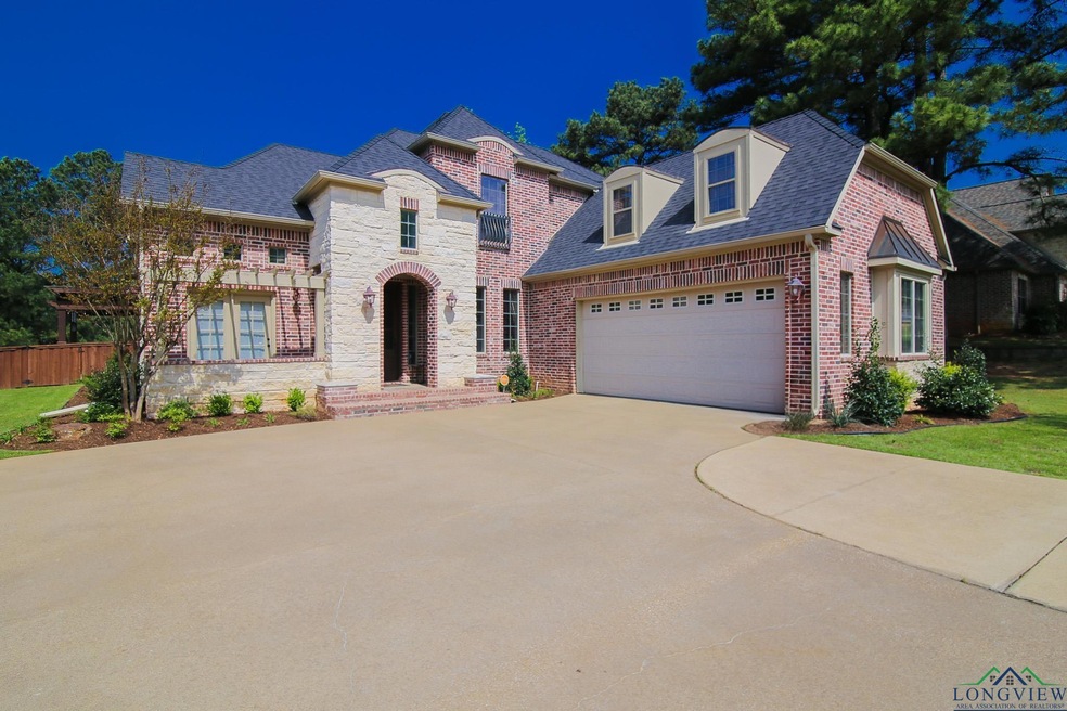 French provincial home featuring stone siding, roo