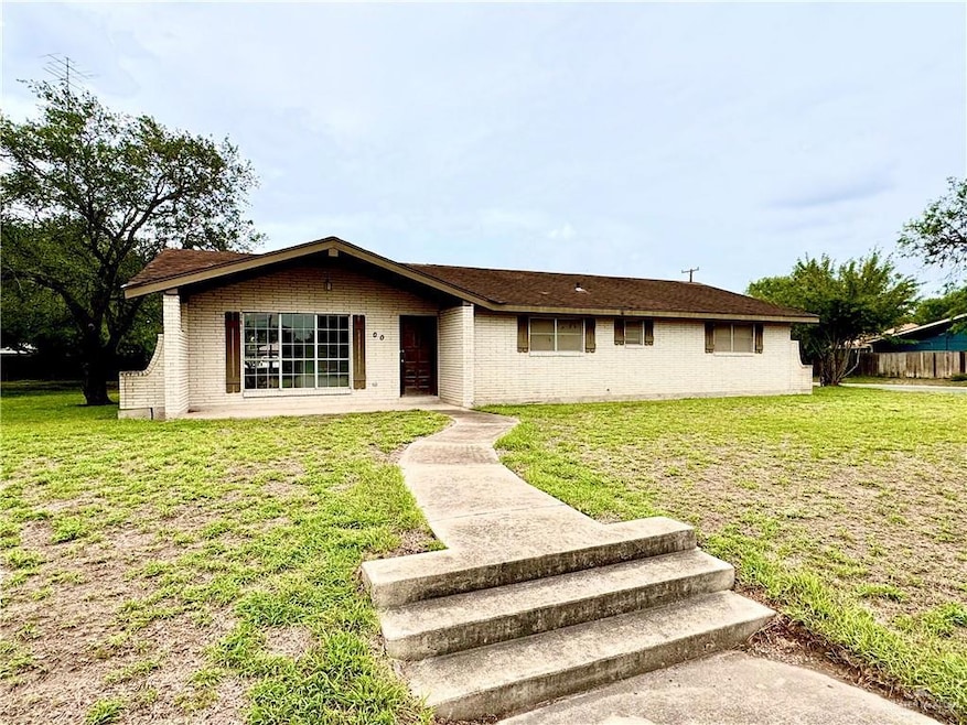 Single story home featuring a front lawn