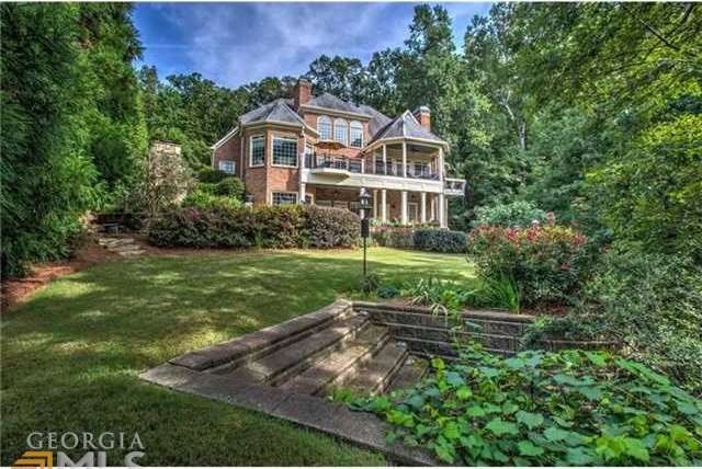 Lake view with beautifully landscaped yard
