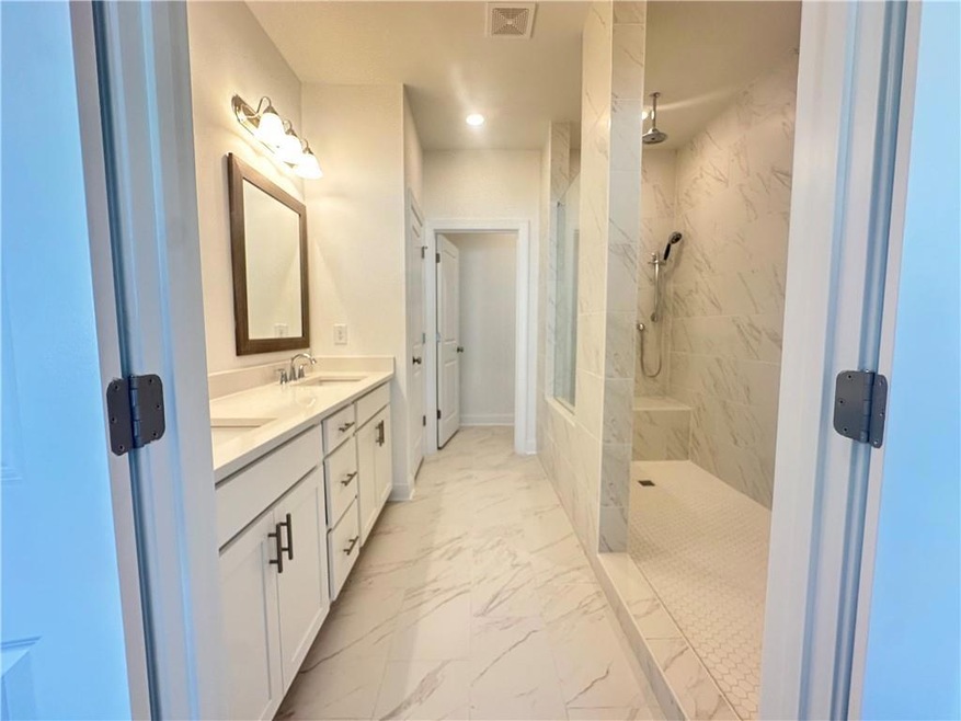 Welcome home to Home Site 68 Featuring Owners Walk Through Shower with Frameless Glass Door