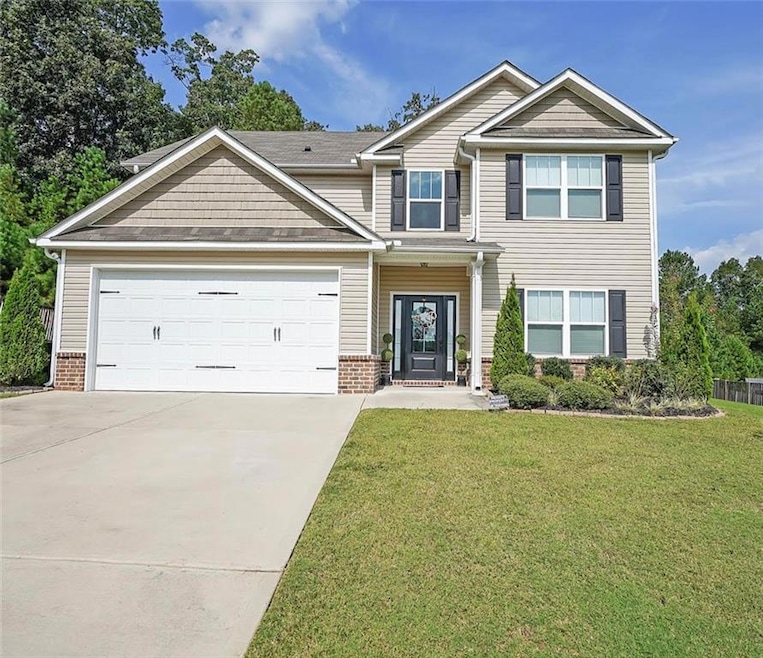 Craftsman-style home featuring brick siding, an at