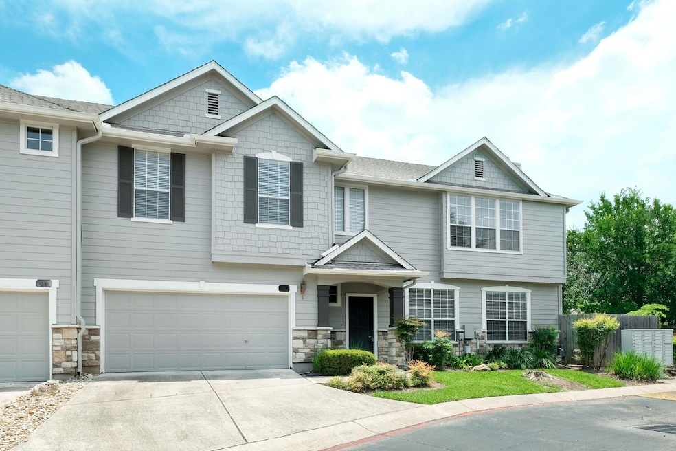 View of front facade with concrete driveway, a ga