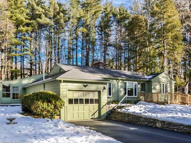Exterior Front. Nestled in amongst some tall trees